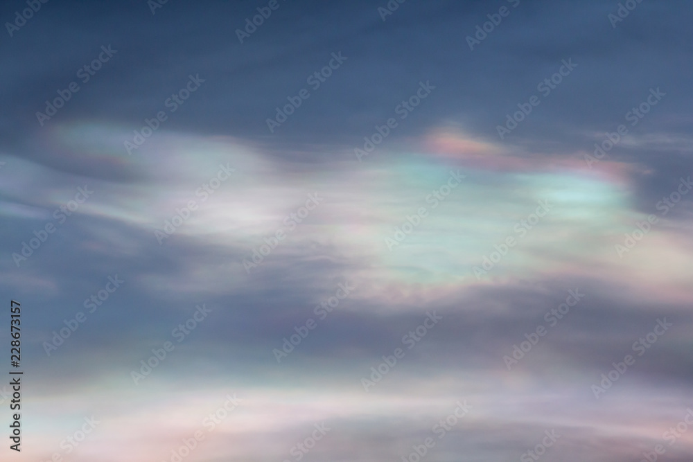 Cloud iridescence or irisation, polar stratospheric clouds on blue sky.