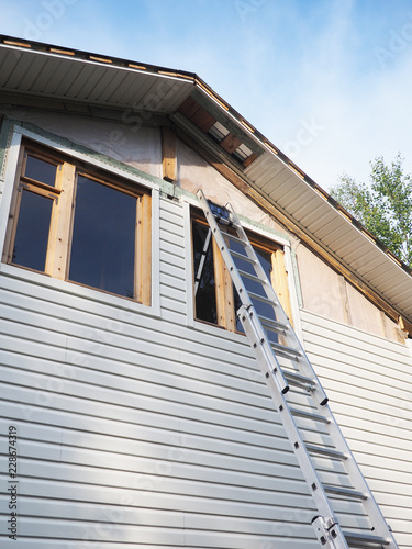 Construction of the frame house. Siding installation