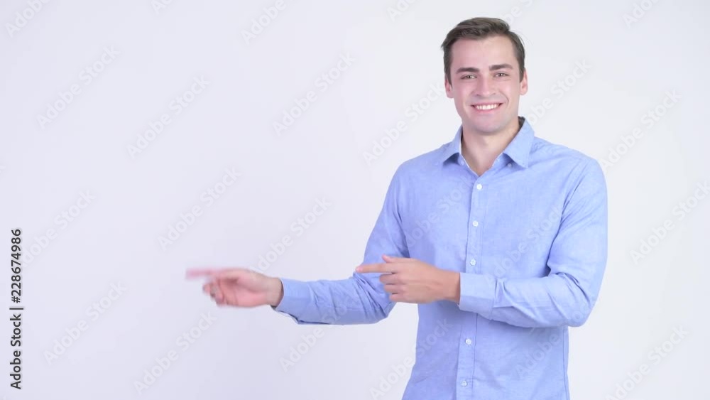 Young happy handsome businessman showing something Young happy handsome businessman showing something