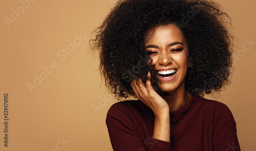 Portrait of laughing african american girl with copy space photo