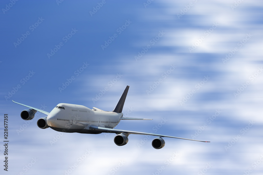 Obraz premium Big white airplane is flying over the clouds with colorful sky at sunset for Business trip with Commercial plane , Transportation, import-export and logistics, Travel concept