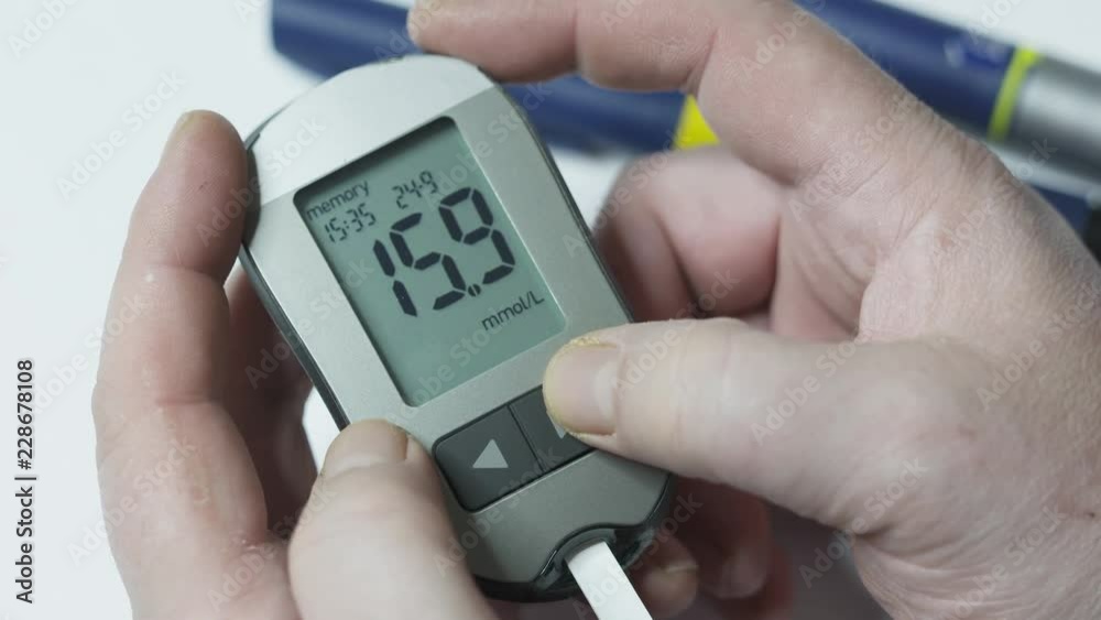 Patient with diabetes using a blood glucose meter. Viewing 30‑day blood glucose test results stored in memory of glucometer. Blood sugar levels from high to normal after insulin therapy.
