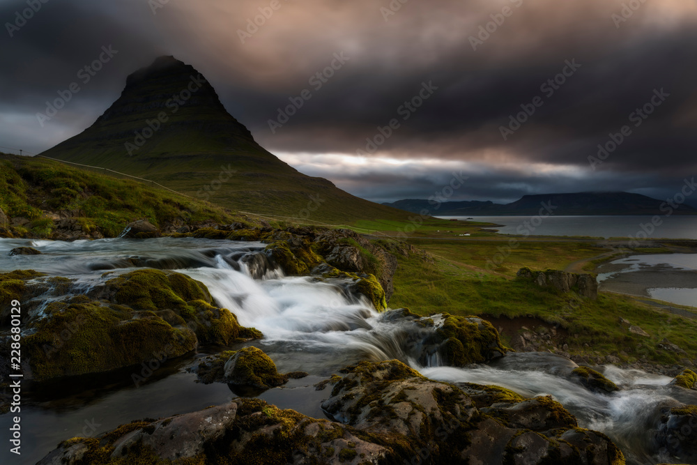 Kirkjufell volcano the coast of Snaefellsnes peninsula. Picturesque and gorgeous scene. Location Kirkjufellsfoss, Iceland, sightseeing Europe. Breathtaking picture of the popular tourist attraction.