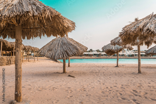 beach umbrellas made from natural materials by the sea