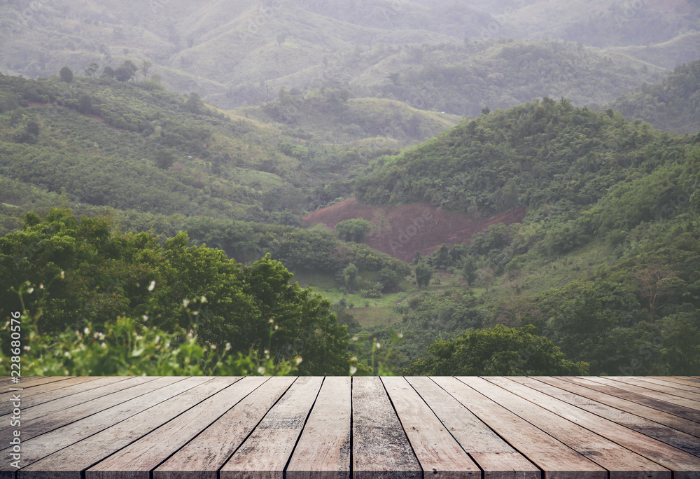 Wood desk or wood floor for product diskplay with rainy clouds and mountain natural background Wood desk or wood floor for product diskplay with rainy clouds and mountain natural background