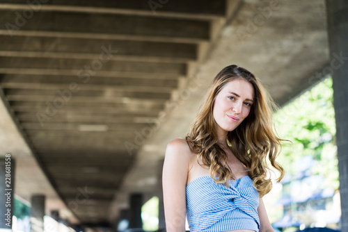 Portrait of smiling long-haired woman at underpass