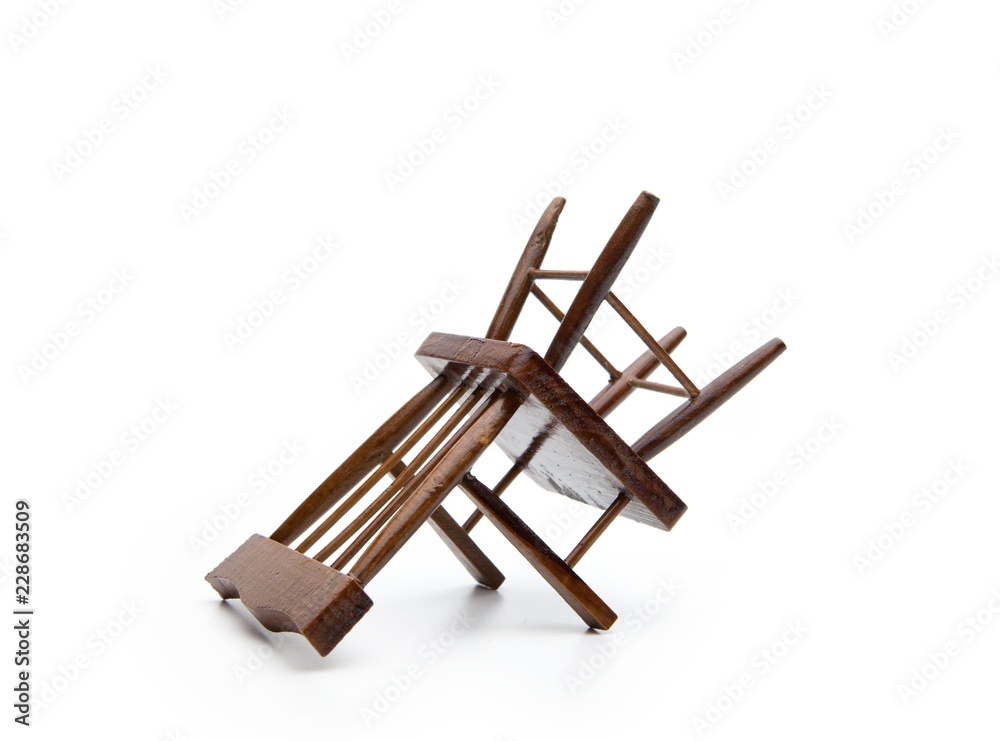 A chair (miniature) upside down, isolated on white. A chair (miniature) upside down, isolated on white.