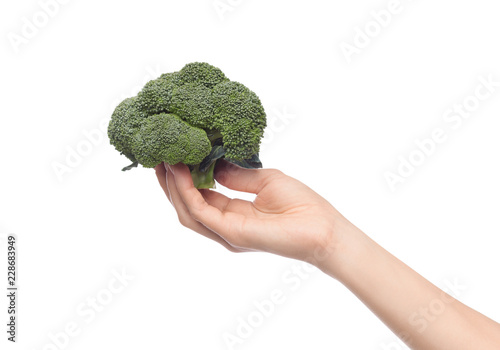 Female hand holding broccoli isolated on white