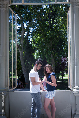 Fototapeta Naklejka Na Ścianę i Meble -  Young couple in love enjoy a sunny day in the park 