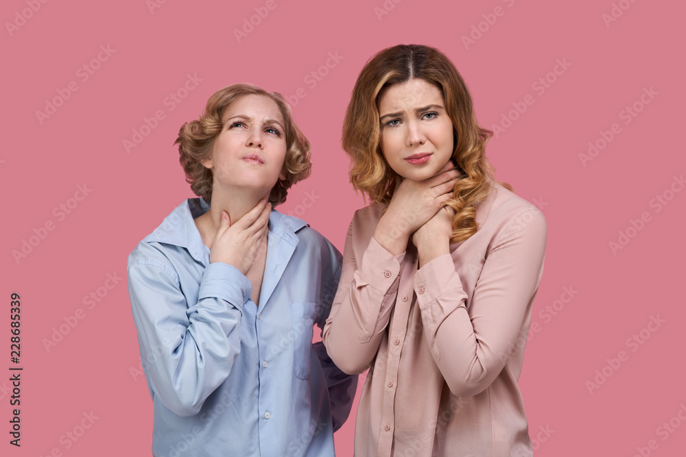 Sad desperate woman suffer from asthma or pain in the throat, has the unfortunate stiff, keep hands on the neck. Two young women has asphyxiation, holds hands around her neck, suffers from sore throat Sad desperate woman suffer from asthma or pain in the throat, has the unfortunate stiff, keep hands on the neck. Two young women has asphyxiation, holds hands around her neck, suffers from sore throat