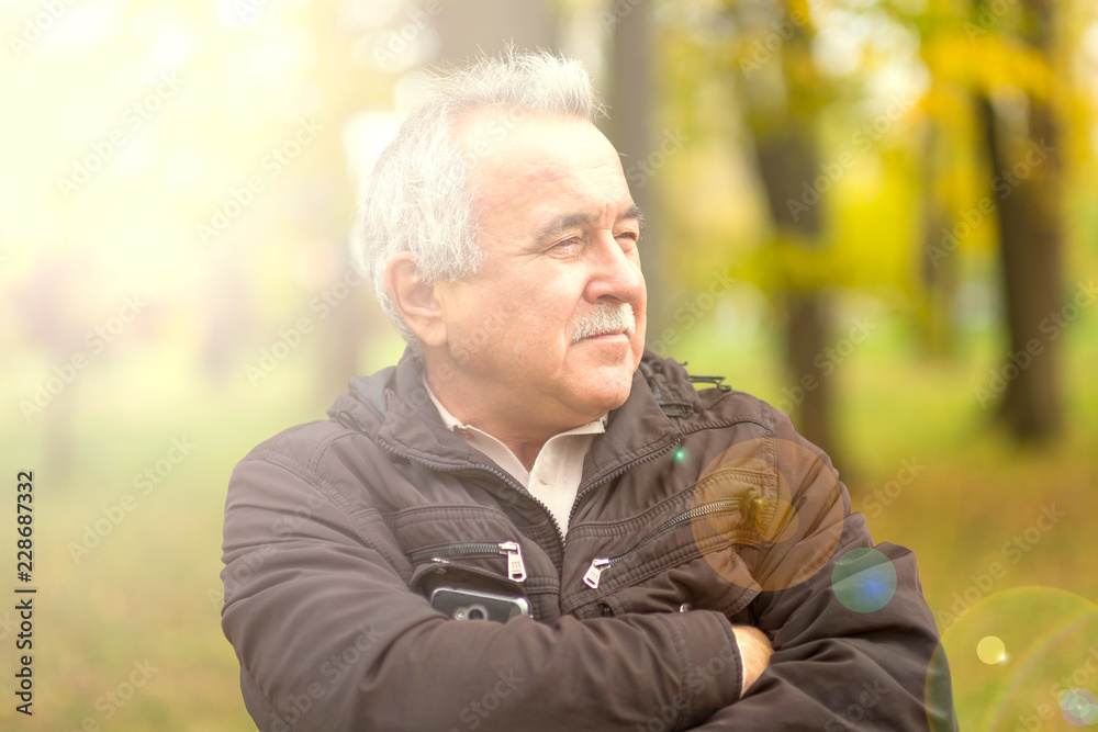 Portrait of an elderly man in the park. Portrait of an elderly man in the park.
