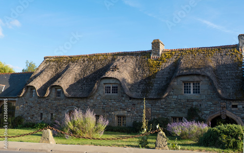 Traditional stone house with thatched roof in Brittany France . Brittany Normandy France
