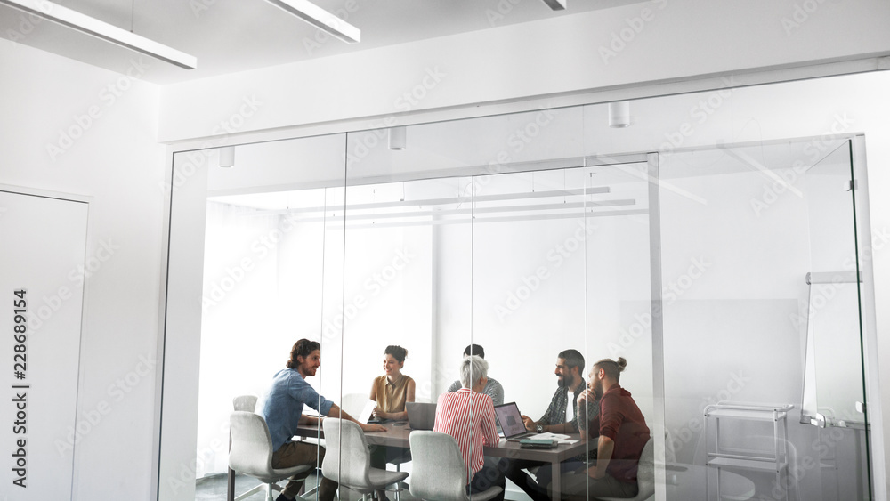 Group of young businesspeople having a meeting at meeting room. Group of young businesspeople having a meeting at meeting room.