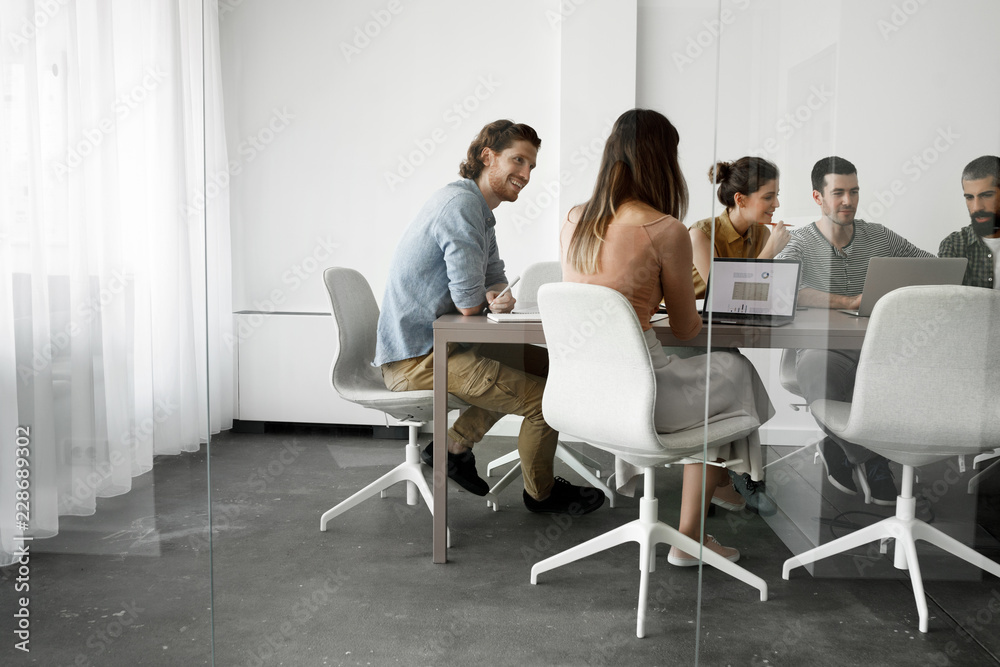Group of young businesspeople having a meeting at meeting room. Group of young businesspeople having a meeting at meeting room.
