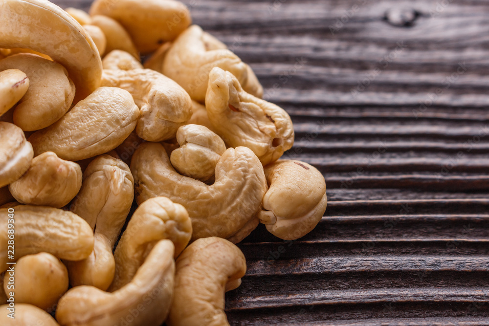 cashew nuts on a rustic wooden background cashew nuts on a rustic wooden background