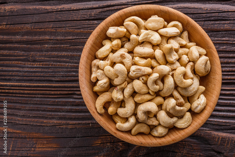 cashew nuts on a rustic wooden background cashew nuts on a rustic wooden background