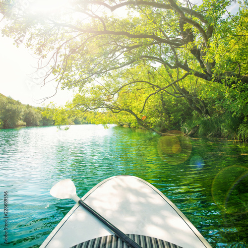 paddle board with oar in mountain river
