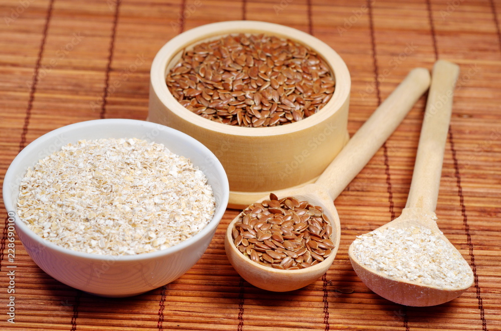 Flax seeds and oat bran on bamboo napkin Flax seeds and oat bran on bamboo napkin
