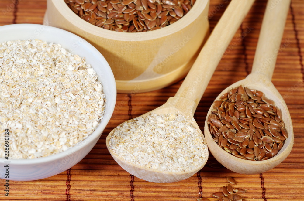 Flax seeds and oat bran on bamboo napkin close-up Flax seeds and oat bran on bamboo napkin close-up