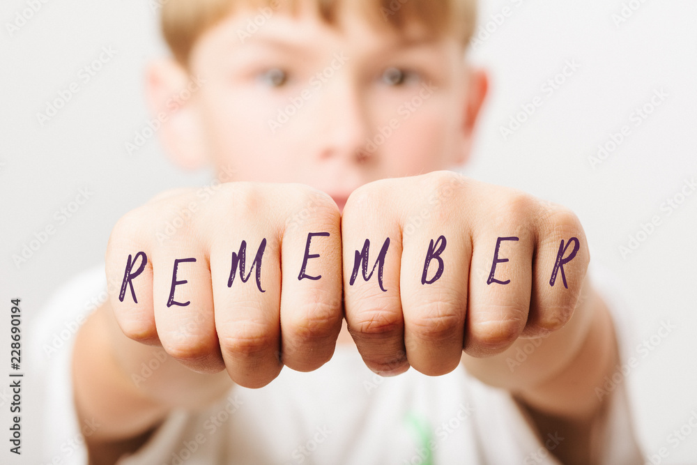Remember word on fists of school boy - obrazy, fototapety, plakaty 