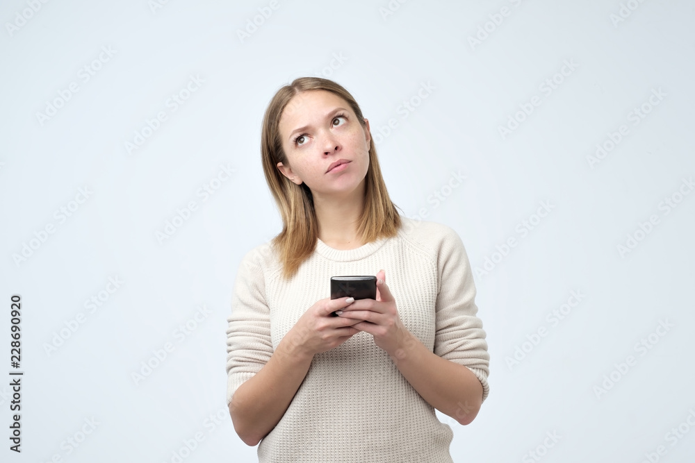 Split up message for boyfriend. Young cute attractive woman is writing some text or using a smart phone Split up message for boyfriend. Young cute attractive woman is writing some text or using a smart phone