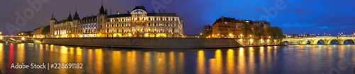 Panorama of Seine river , Conciergerie between Pont au Change i and pont Neuf n Paris at night, France.