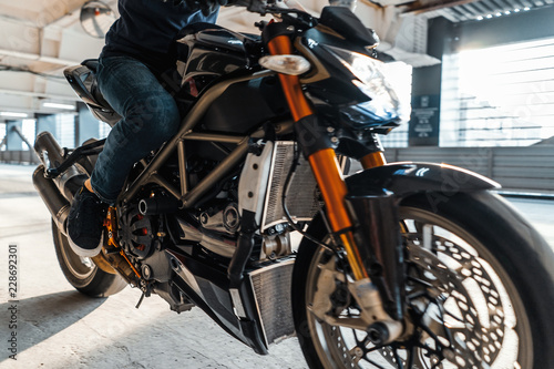 Close up of high power motorcycle on urban background at parking.