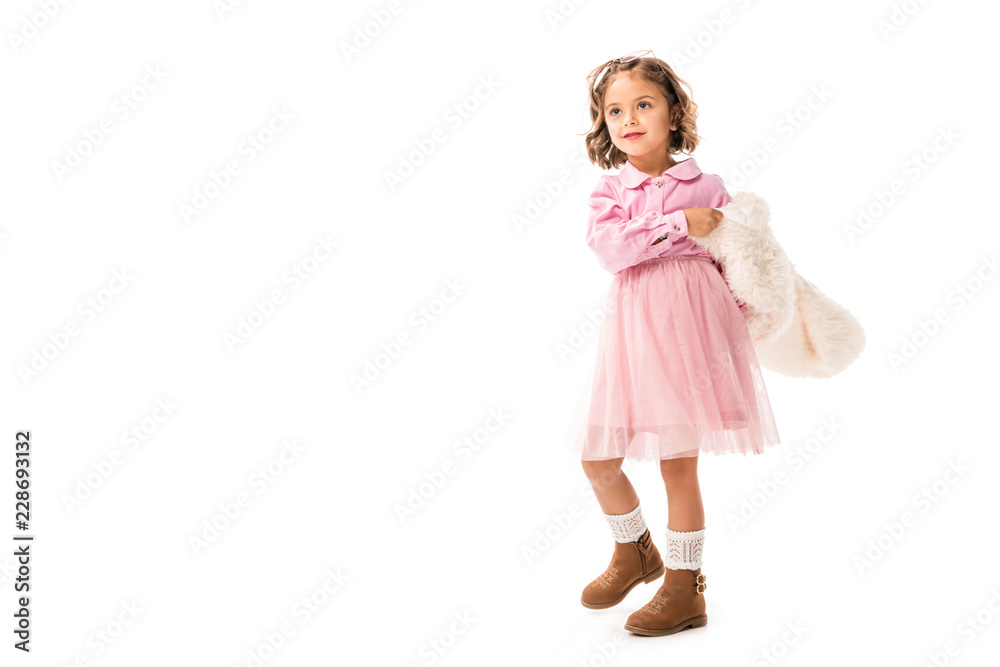 adorable little child in pink clothes and white fur coat isolated on white