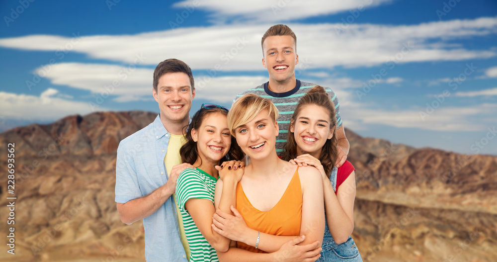 travel, tourism and vacation concept - group of happy smiling friends over grand canyon national park background travel, tourism and vacation concept - group of happy smiling friends over grand canyon national park background