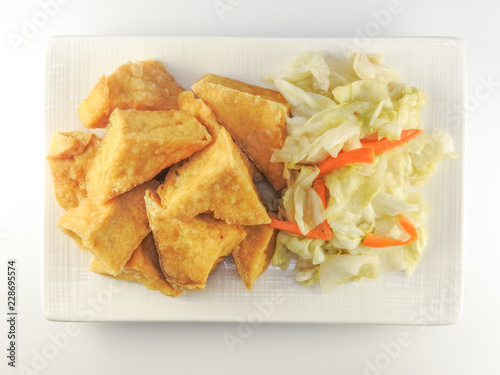 Top view of fried stinky tofu with pickle vegetable isolated on white background. Traditional snack at night market. Oriental,Asia,Taiwan food concept.With copy space.