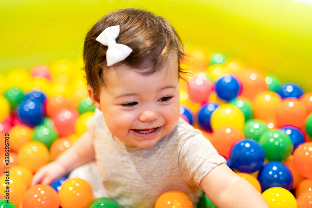 Obraz premium Portrait of a adorable infant on colorful balls
