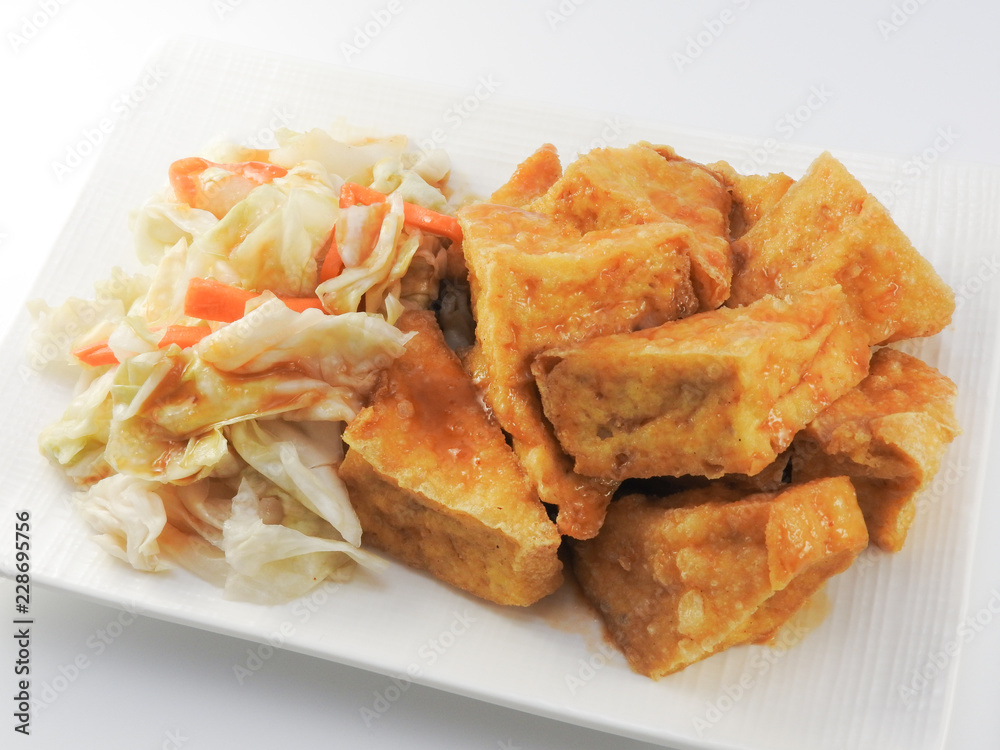 High angle view of fried stinky tofu with pickle vegetable isolated on white background. Traditional snack at night market. Oriental,Asia,Taiwan food concept.With copy space. High angle view of fried stinky tofu with pickle vegetable isolated on white background. Traditional snack at night market. Oriental,Asia,Taiwan food concept.With copy space.