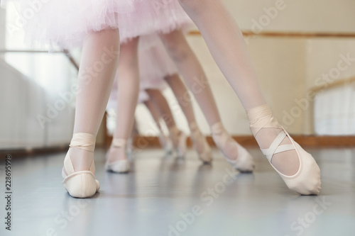Little ballerinas training leg position at ballet class, copy space.