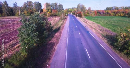 cars drive through the country road