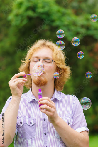 Man blowing soap bubbles  having fun