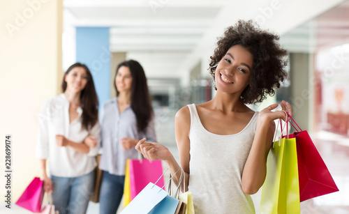 African-american woman with shopping bags in mall