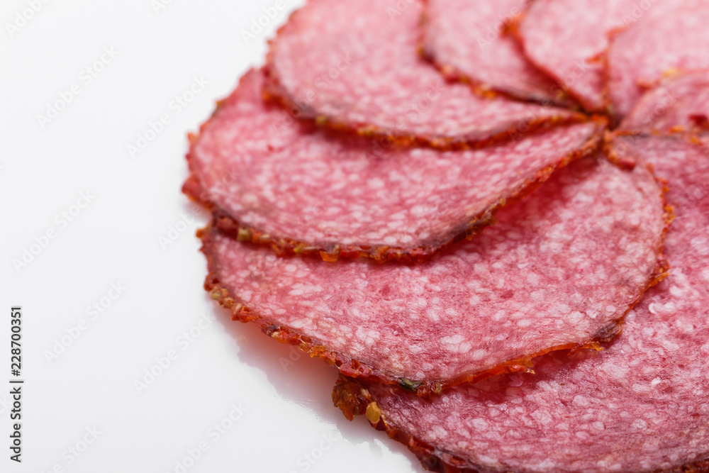 delicious sliced salami on a white background