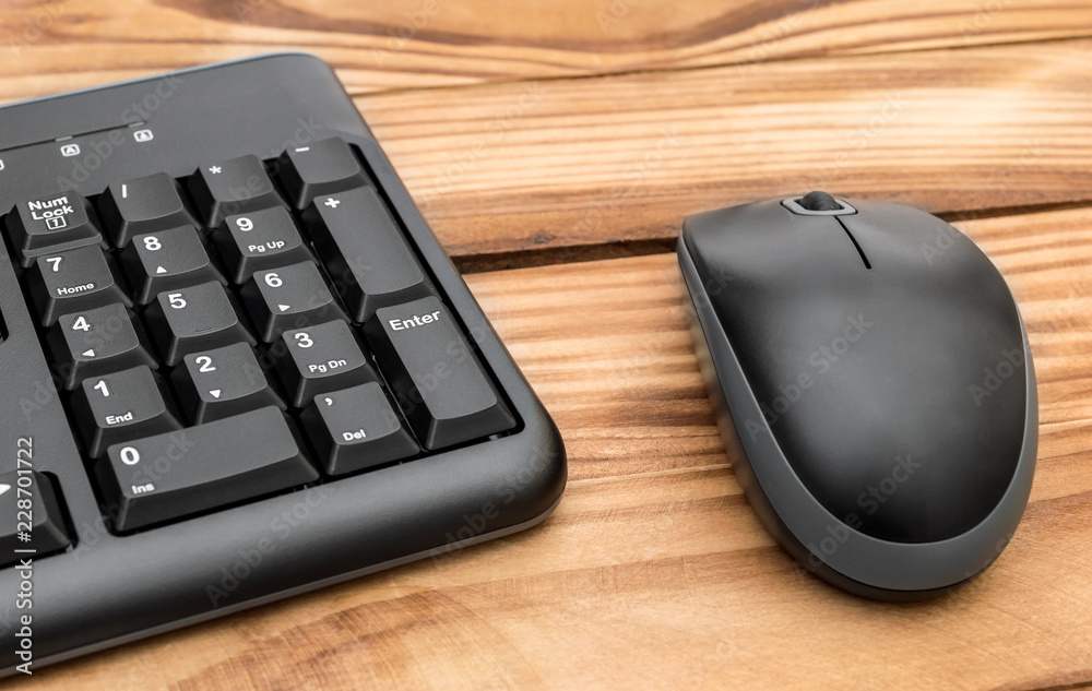 Computer keyboard with computer mouse on wooden table. Computer keyboard with computer mouse on wooden table.