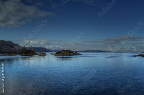 View over a Scottish lake with blue reflection
