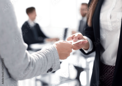 close up.two business woman exchanging business card