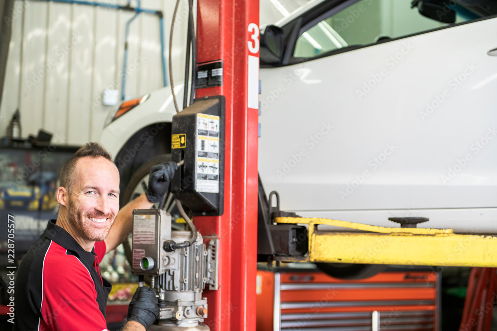 handsome mechanic based on car in auto repair shop handsome mechanic based on car in auto repair shop