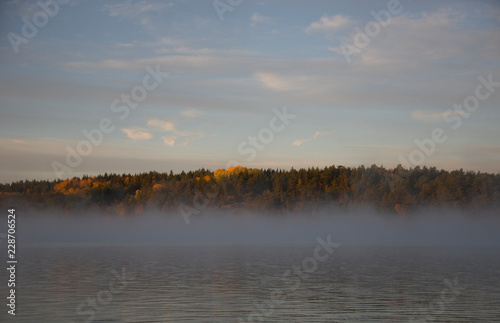 Canvas Print Lake Malaren in stockholm an early cold and foggy autumn day, shilouettes and re