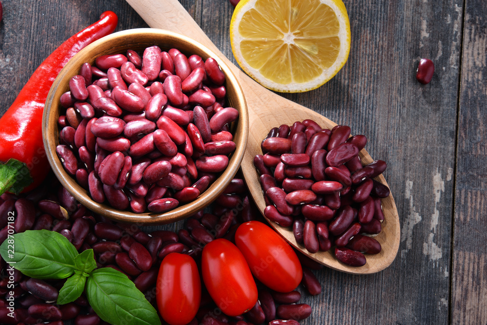 Composition with bowl of kidney bean on wooden table Composition with bowl of kidney bean on wooden table