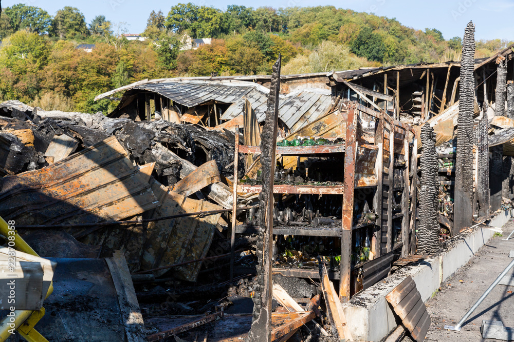 Burned damaged ruins of destroyed supermarket arson investigation insurance Burned damaged ruins of destroyed supermarket arson investigation insurance