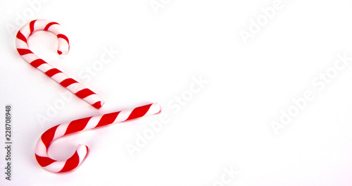 Two red and white candy canes. Christmas and New Year holiday background concept. Blank space for greetings.