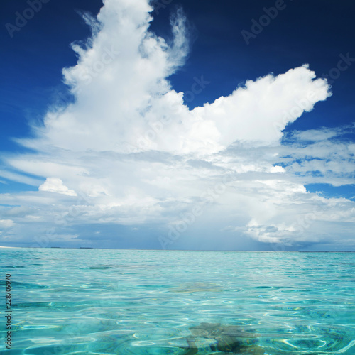 Beautiful tropical seascape. Ocean waves and cloudy sky background. Crystal-blue sea. Ocean water nature  beach relax. Summer sea vacation