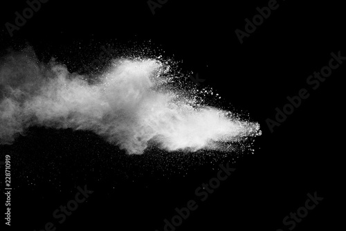 Tablou canvas Explosion of white dust on black background.