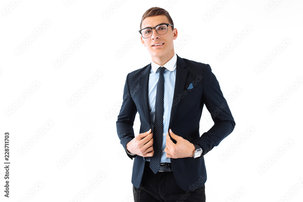 Business elegant man, in a suit and glasses, posing on a white background Business elegant man, in a suit and glasses, posing on a white background