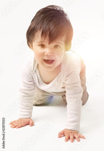 the baby learns to crawl isolated on white background