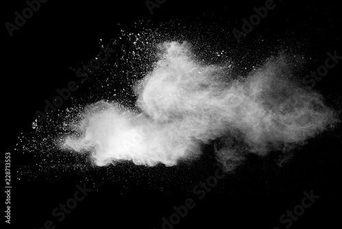 Explosion of white dust on black background.